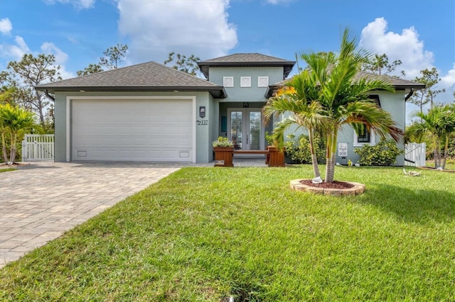 view of front of property featuring a garage and a front lawn