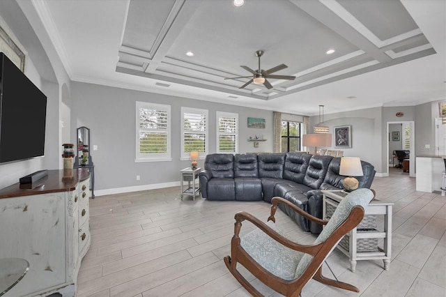 living room with ceiling fan, a healthy amount of sunlight, and coffered ceiling