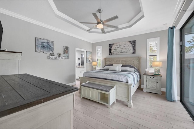 bedroom featuring ornamental molding, a tray ceiling, light hardwood / wood-style floors, and ceiling fan