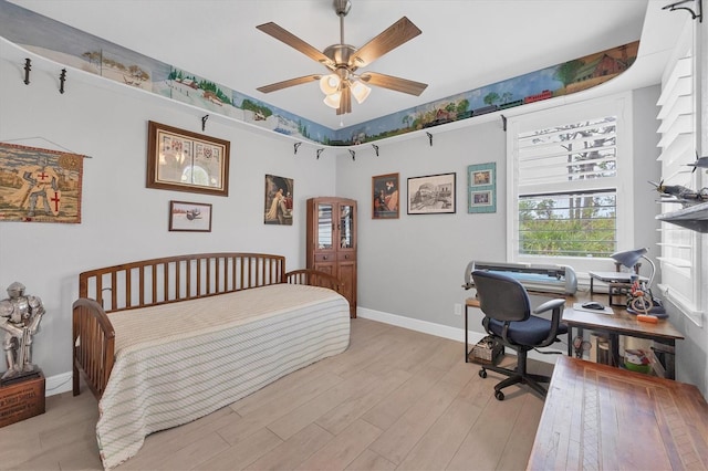 bedroom with ceiling fan and light hardwood / wood-style floors