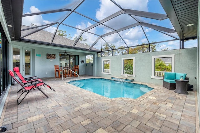 view of pool with a patio, a lanai, ceiling fan, and pool water feature