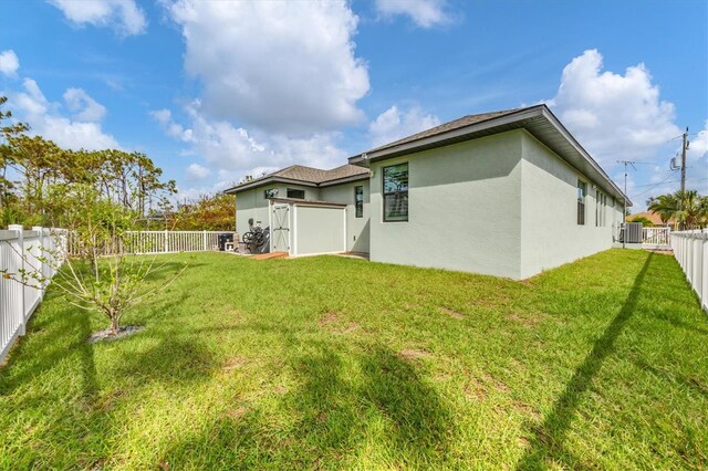 rear view of property with central air condition unit and a lawn