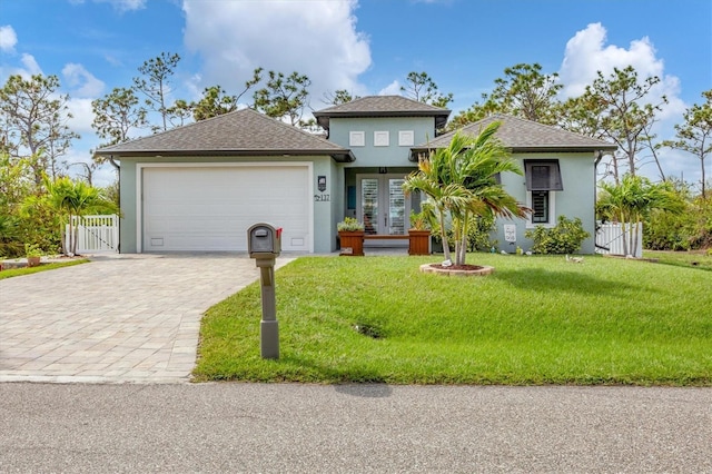 view of front of home with a front lawn and a garage