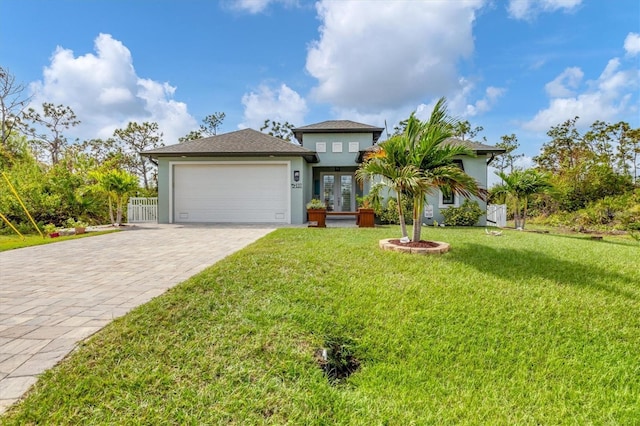 view of front of home with a garage and a front yard