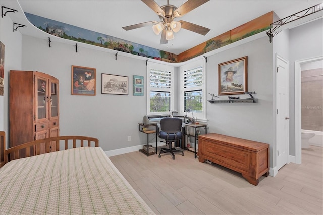 bedroom with ensuite bath, ceiling fan, and light hardwood / wood-style flooring