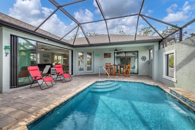 view of pool with french doors, a patio area, ceiling fan, pool water feature, and a lanai