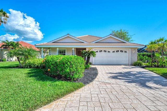 view of front of home featuring a garage and a front lawn