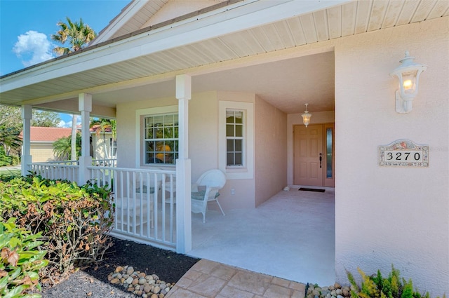 entrance to property featuring covered porch