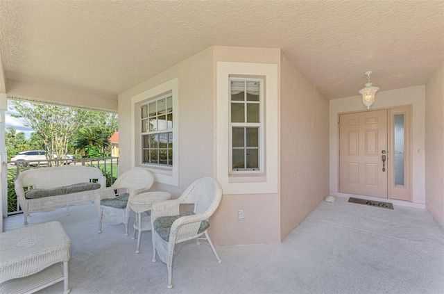 view of exterior entry featuring covered porch