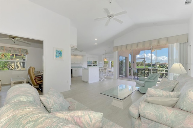 living room with ceiling fan, light wood-type flooring, and lofted ceiling