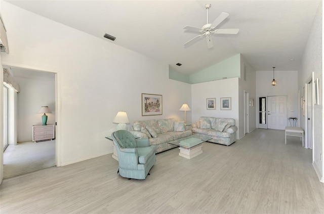 living room with ceiling fan, high vaulted ceiling, and light hardwood / wood-style flooring