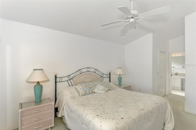 bedroom with ceiling fan, vaulted ceiling, light carpet, and a closet