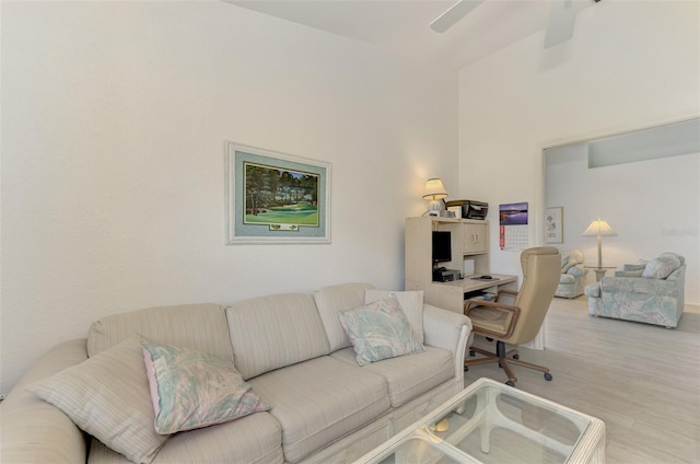 living room with ceiling fan and light hardwood / wood-style floors