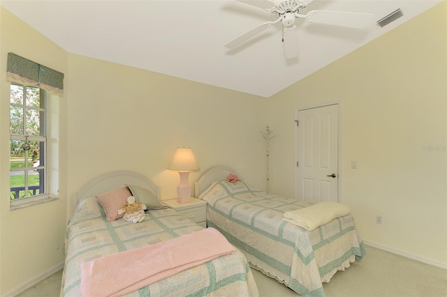 bedroom featuring ceiling fan, light colored carpet, and vaulted ceiling