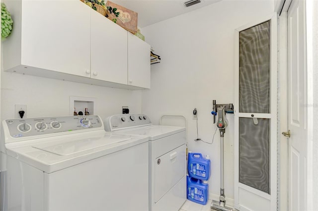 laundry room featuring cabinets and washing machine and dryer