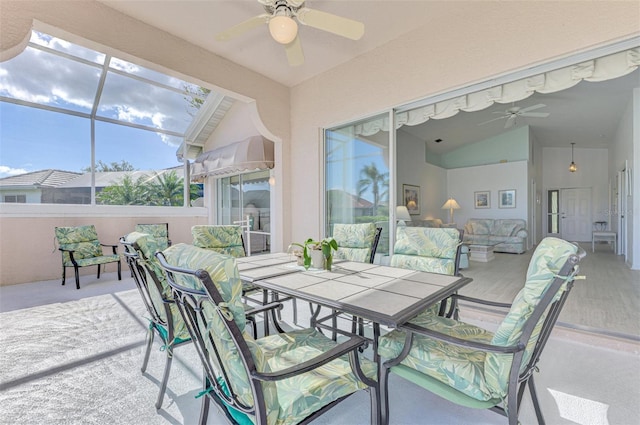 sunroom with ceiling fan and vaulted ceiling