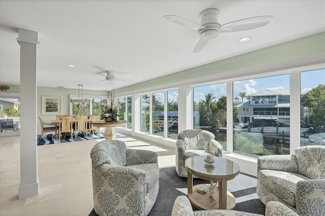 sunroom / solarium featuring ceiling fan and a healthy amount of sunlight