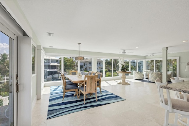 sunroom with ceiling fan