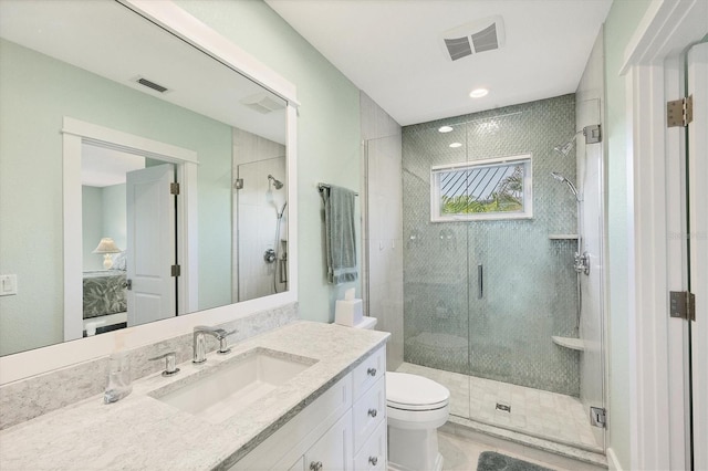 bathroom with toilet, vanity, and walk in shower