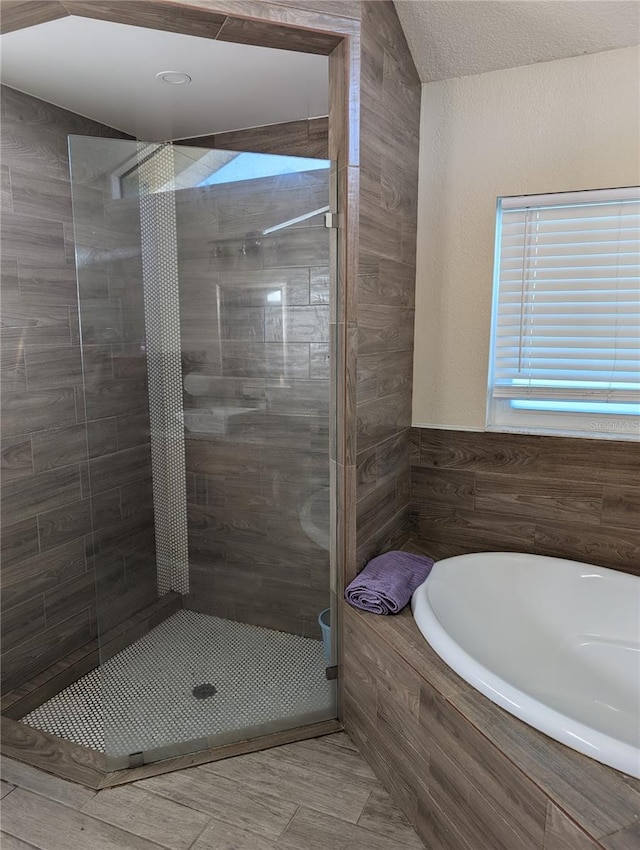 bathroom with shower with separate bathtub