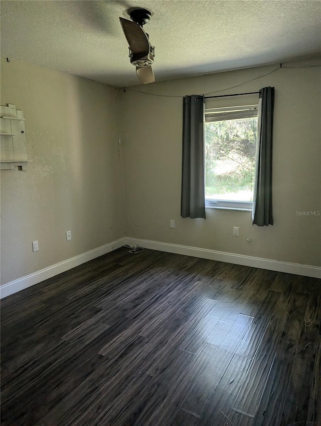 unfurnished room featuring a textured ceiling and dark wood-type flooring