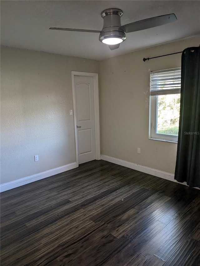 empty room with dark hardwood / wood-style floors