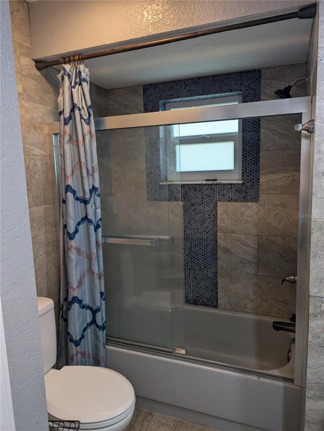 bathroom with hardwood / wood-style floors, shower / bath combo, and toilet