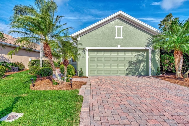 view of front facade with a garage and a front yard