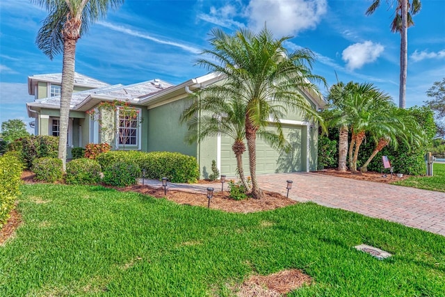 view of front of house with a garage and a front yard