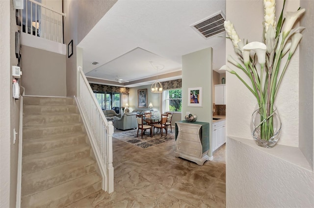 foyer with a textured ceiling and a notable chandelier