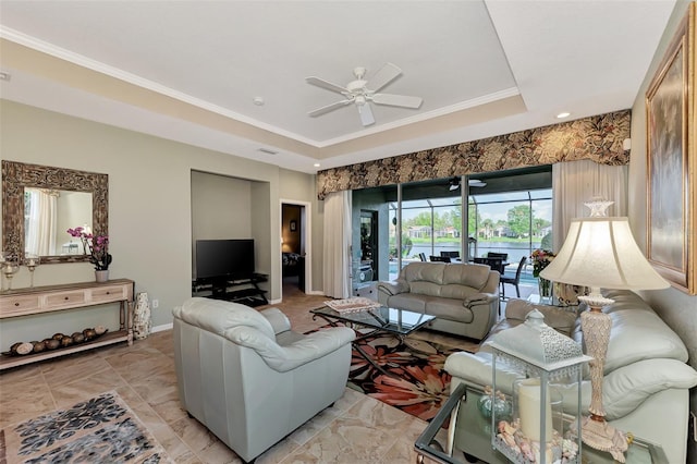 living room featuring crown molding, ceiling fan, and a raised ceiling