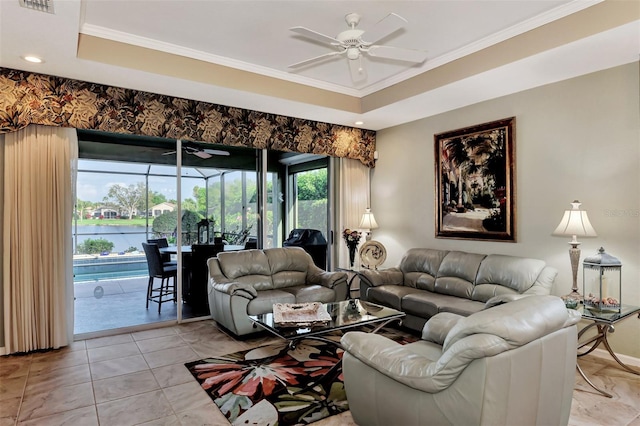 living room with ceiling fan, a raised ceiling, and crown molding