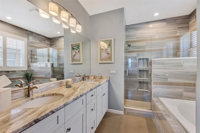 bathroom with tile patterned flooring, vanity, and shower with separate bathtub