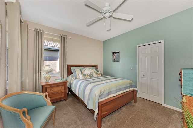 carpeted bedroom featuring a closet and ceiling fan