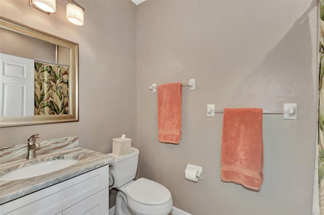 bathroom featuring toilet and vanity