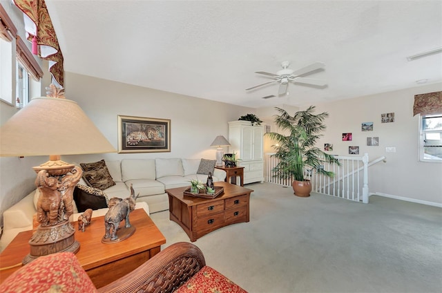 carpeted living room featuring ceiling fan