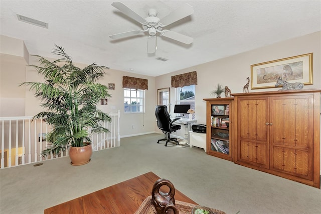 office space with ceiling fan, a textured ceiling, and carpet floors