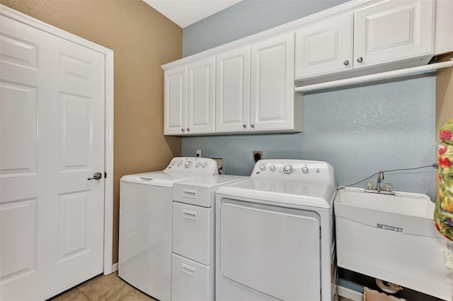 laundry area featuring cabinets, sink, and independent washer and dryer