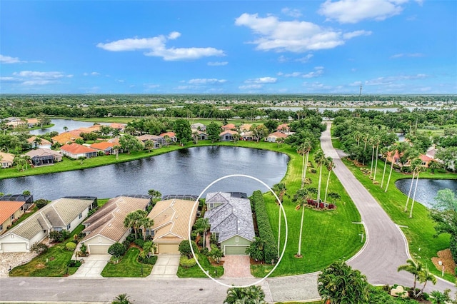 birds eye view of property with a water view