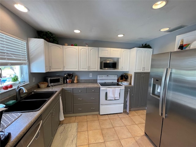 kitchen featuring sink, gray cabinets, light tile patterned flooring, white cabinetry, and stainless steel appliances