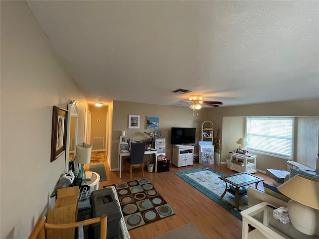 living room featuring hardwood / wood-style floors and ceiling fan