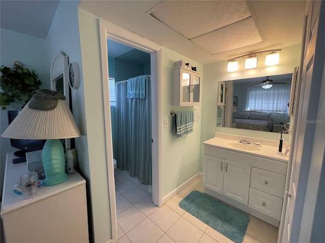 bathroom featuring tile patterned floors, walk in shower, vanity, ceiling fan, and toilet