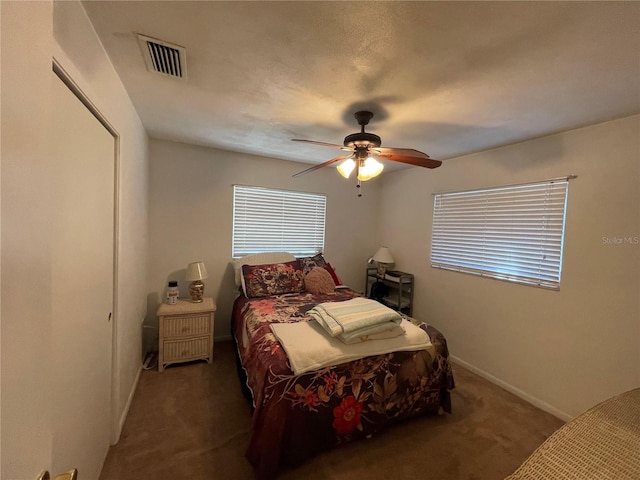 bedroom with dark colored carpet and ceiling fan