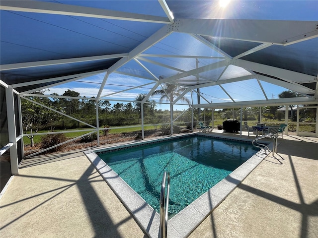 view of swimming pool featuring a lanai and a patio