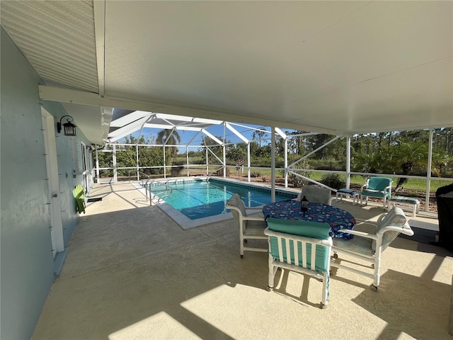 view of swimming pool featuring a lanai and a patio