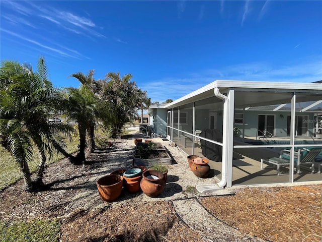 view of home's exterior featuring a lanai and a patio