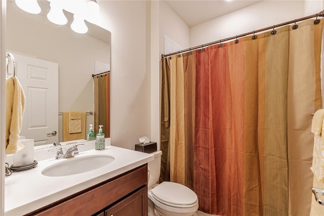 bathroom featuring a shower with curtain, vanity, and toilet