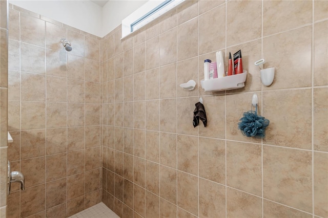 bathroom with a tile shower