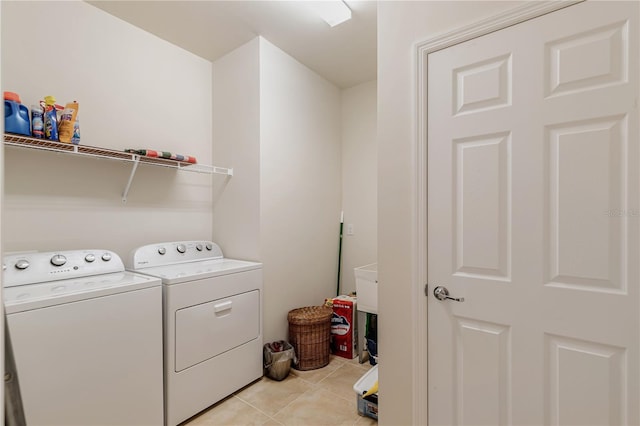 laundry room featuring washing machine and dryer and light tile patterned floors