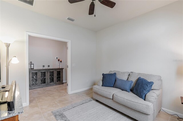 living room with ceiling fan and light tile patterned flooring